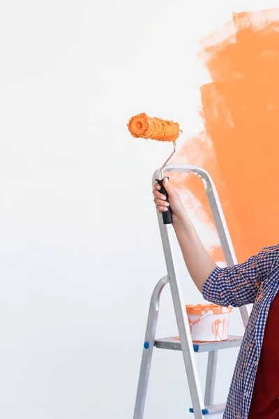 Close up of woman painting wall. Renovation, redecoration and repair concept. — Stock Photo, Image