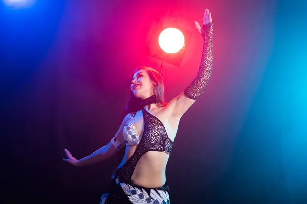 Mujer joven bailando al estilo Tribal Fusion. Danza del vientre en el escenario . — Foto de Stock