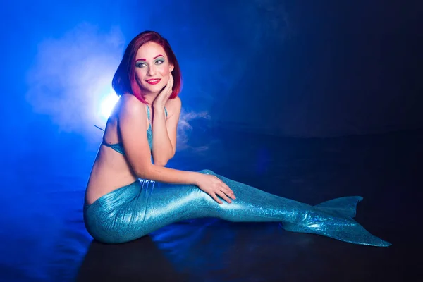 Mermaid with red hair resting on blue background. Fantasy concept. — Stock Photo, Image