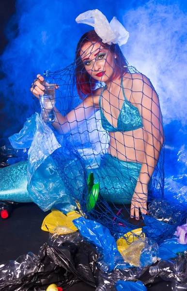 Fantasy stupid mermaid in deep ocean. Plastic water bottles and bags pollution on sea floor. Environmental problem. — Stock Photo, Image