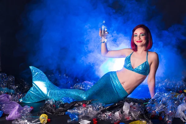 Stupid fairytale mermaid in polluted ocean. Plastic trash and garbage in water. Environmental problem, plastic bag and bottles polluting a coral reef. — Stock Photo, Image