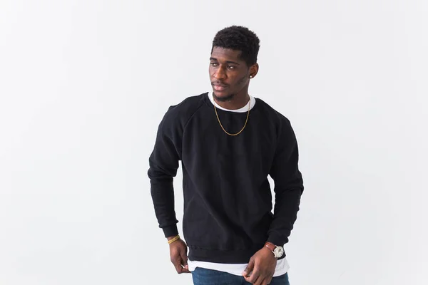 Street fashion concept - Studio shot of young handsome African man wearing sweatshirt against white background. — Stock Photo, Image