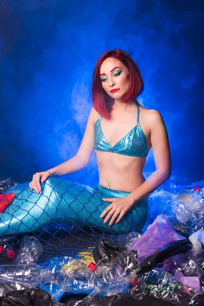 Sea plastic pollution concept. Mermaid in the ocean. Plastic is everywhere. Environmental protection.