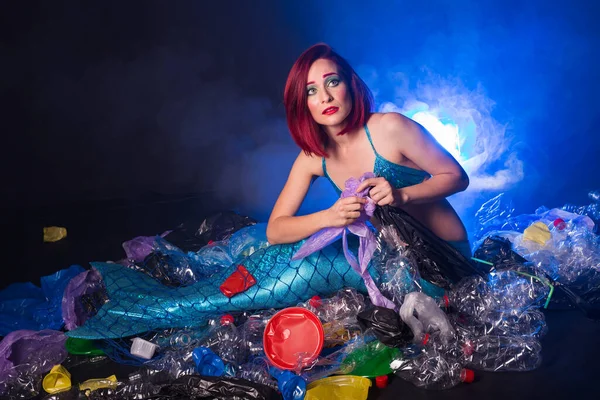 Sad fairytale mermaid in polluted ocean. Plastic trash and garbage in water. Environmental problem, plastic bag and bottles polluting a coral reef. — Stock Photo, Image