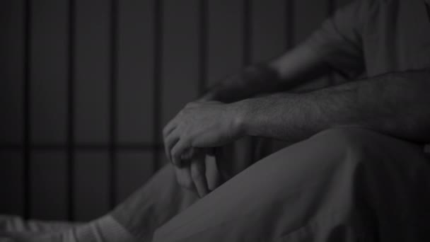 Man inmate sitting in jail cell — Stock Video