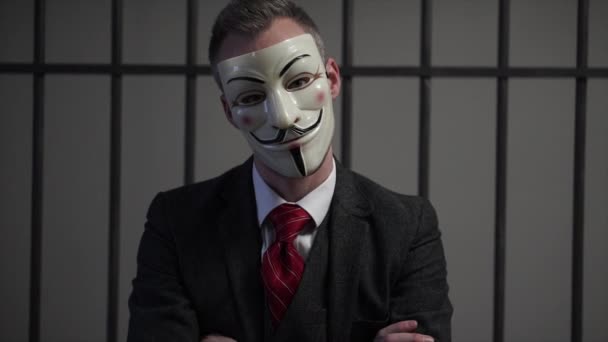 Anonymous hacker in prison has head tilted with attitude — Stock Video