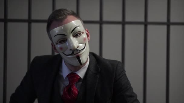 Scene of suited Anonymous hacker in prison — Stock Video