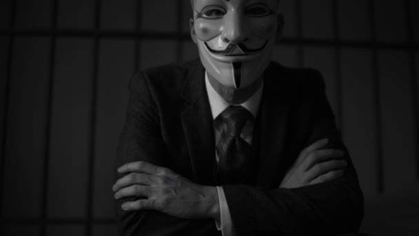 Dramatic shot of Anonymous hacker in prisonn (B/W Version) — Stock Video