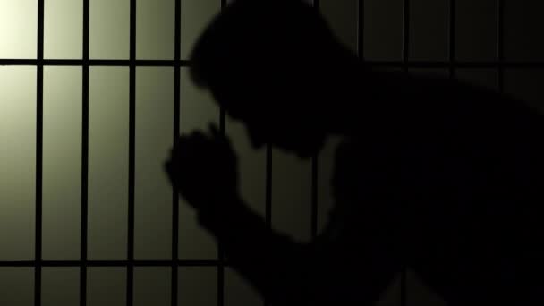 Silhouette of man in prison — стоковое видео