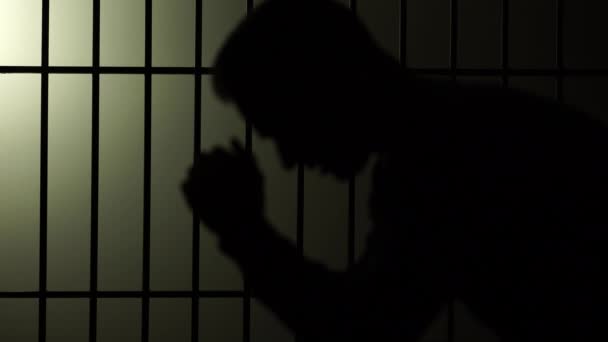 Silhouette of man in jail — Stock Video