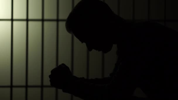 Silhouette of man in prison — стоковое видео