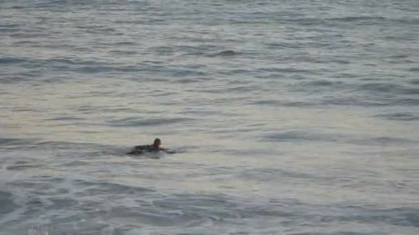 Surfer bei Sonnenuntergang am schönen Tesa-Strand — Stockvideo