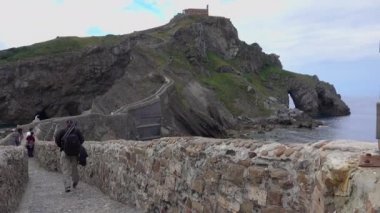 San Juan de Gaztelugatxe doğru adam yürür