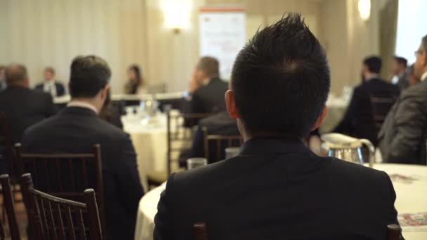 A young man listens at a business event — Stock Video