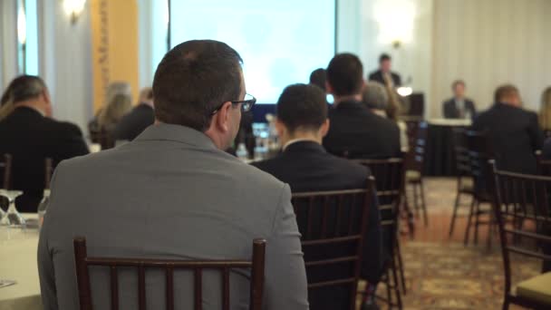 A suited man attends a conference — Stock Video