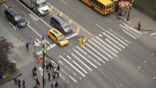 Aerial view of people walking across crosswalk of intersection — Stock Video