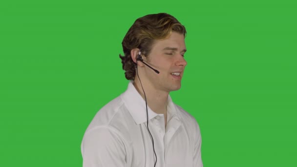 Man handles customer call (Green Key) — Stock Video