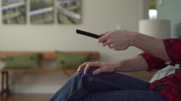 Mans arm as he is changing channels on TV — Stock Video