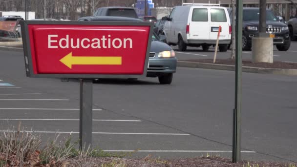 Fast food drive through sign reading Education — стоковое видео