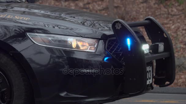 Cars driving by front end of police car — Stock Video