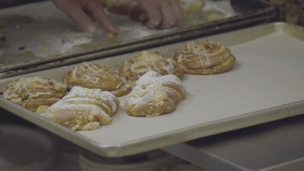 Fresh almond croissants being prepared for sale — Stock Video