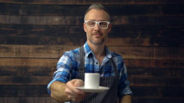 Hipster barrista holds out an espresso — Stock Video