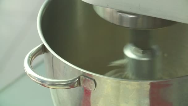 Whipping cream or egg whites in metal bowl with electric mixer machine. — Stock Video