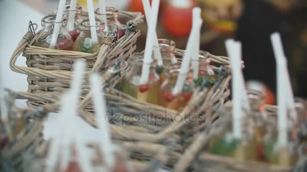 Group of colorful little bottles. Alcoholic cocktails, liqueurs on the white table with cocktail sticks. — Stock Video