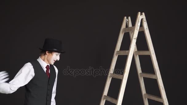 Man mime de ladder klimt, kijkt rond — Stockvideo