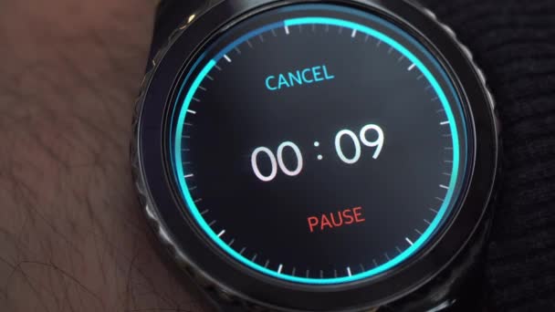 Closeup of a smart watch on male hand. The man turns on the timer. A countdown of 10 seconds before the end of time — Stock Video