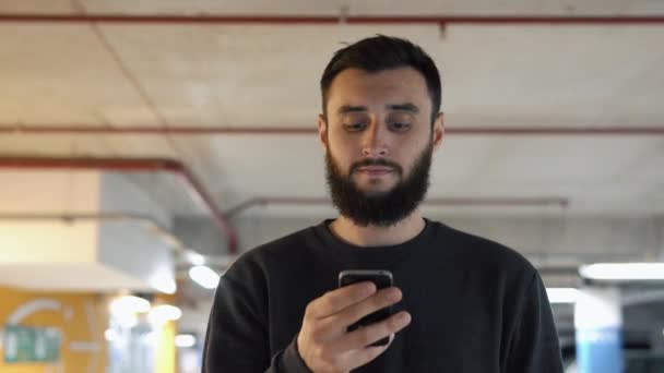 Человек что-то печатает на своем iPhone — стоковое видео