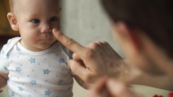 Father touches little boys nose playing on the floor — Stock Video