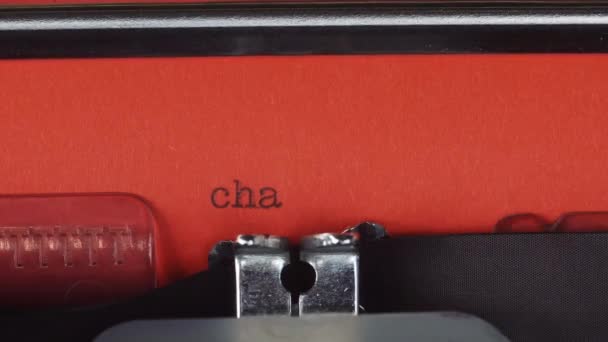 Chapter 2 - Typed on a old vintage typewriter. Printed on red paper. The red paper is inserted into the typewriter — Stock Video