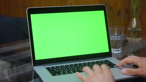 Man works on the laptop with green screen — Stock Video