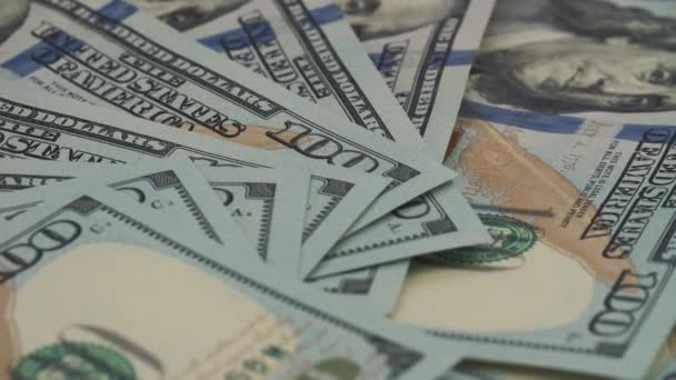 Paper money rotation. The background with the money of the American hundred dollar bills turns counterclockwise. Close-up — Stock Video