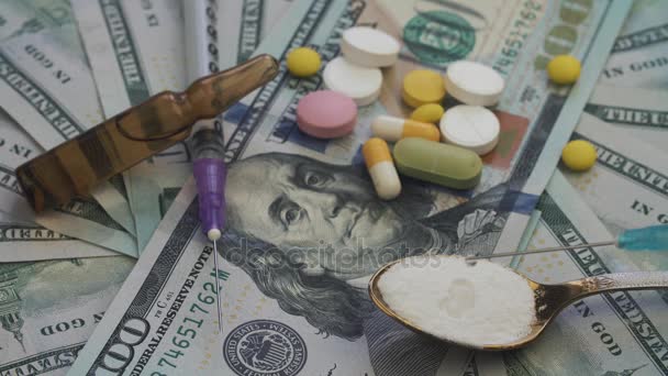 Drugs and pills for addiction lie on the thousands of paper dollars — Stock Video