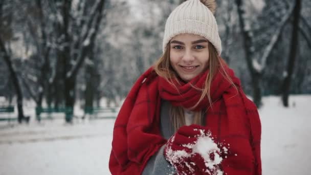 Young Active Woman is Throwing Snowball at the Camera Having Fun Outdoors during Winter Time — Stock Video