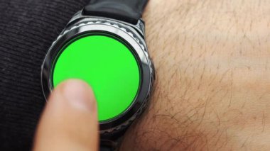 Adam jestleri bir yuvarlak ekran modern smartwatch bir yeşil ekran chroma anahtar içeriği olan üzerinde eller