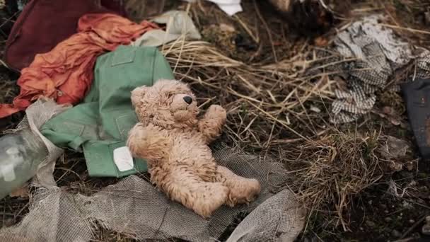 Lost toys, waste and rubber on the ground in the forest — Stock Video