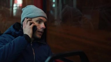 Gece yalnız genç adam rides bir tramvay ve telefon görüşmeleri