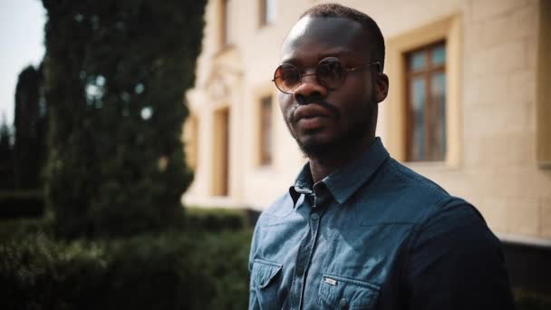 Stilig afrikanska Amrican man vänder sig till den kamera stående på gatan — Stockvideo
