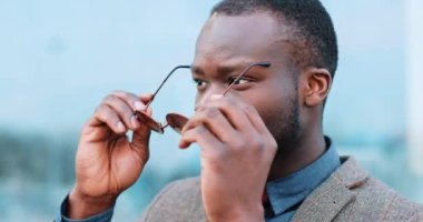 Dışarıda güneş gözlüklerini kırmızı yakışıklı genç Afro-Amerikalı işadamı koyar