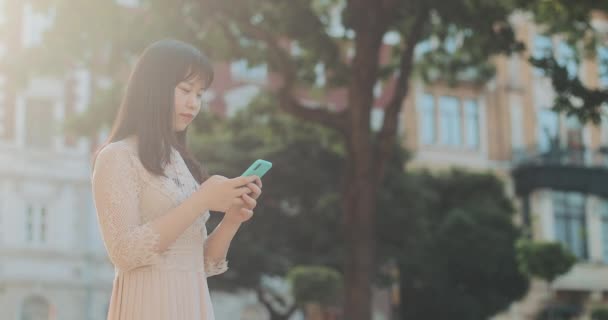 Side view of beautiful girl using mobilephone. — 비디오