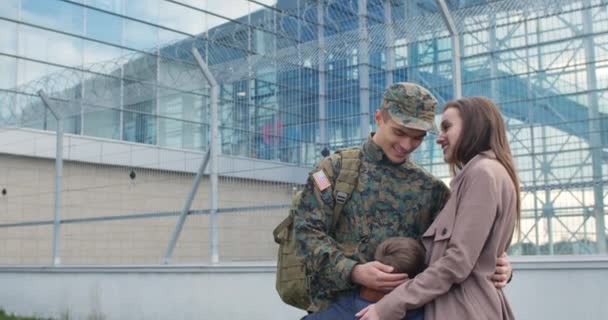 Familj till en militär man som kramas utomhus. — Stockvideo