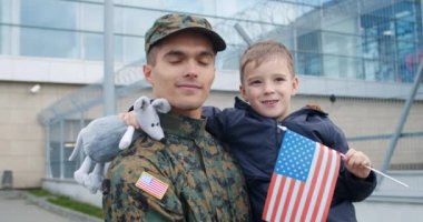Portrait of military dad and his son.
