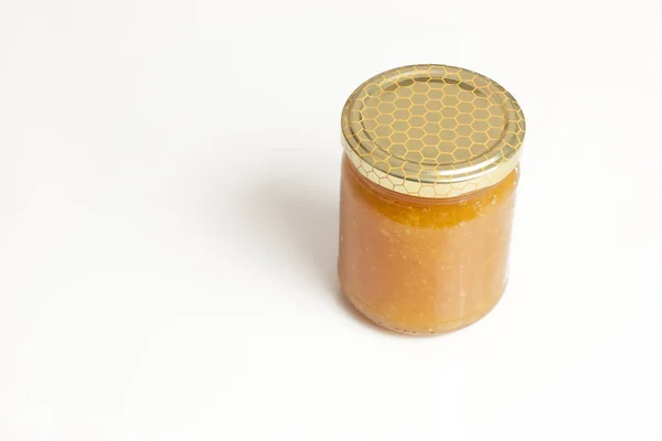 Glass jar of honey on white background — Stock Photo, Image