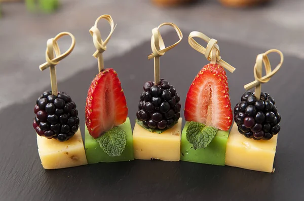 Canapes with cheese and berries. Cheese. Blackberry and strawberry