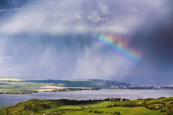 Rainbow after rain. Spring rain and storm in mountains.