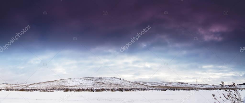 Winter landscape, frozen lake in snow. Snow covered fields