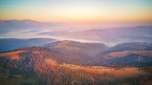 Воздушная панорама осенних гор. Восход солнца над горным туманом — стоковое фото